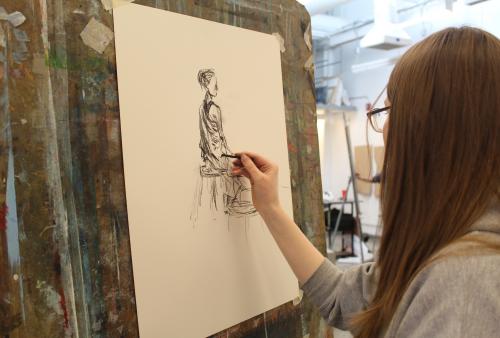 Student drawing figure