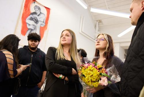 student holding flowers