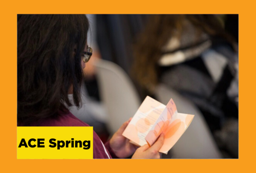 a woman holds a charming handmade book that is colored in soft orange tones