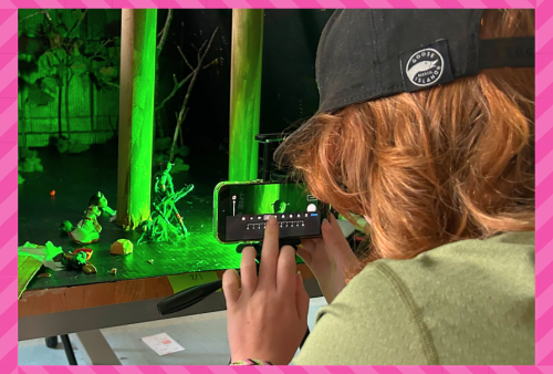 A young artist records stop motion animation of an eerie green forest scene