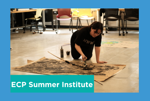 a student paints while on all fours looking over her butcher block paper