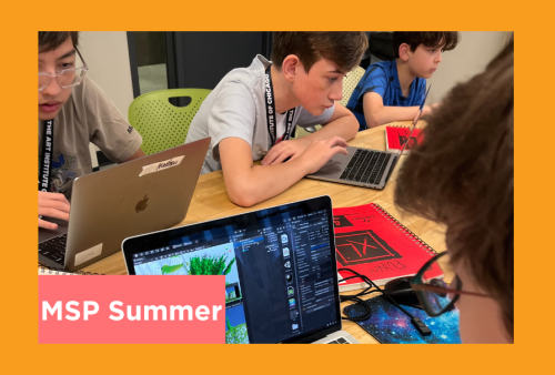 a group of young boys are deep in concentration together as they design video games and nerd out