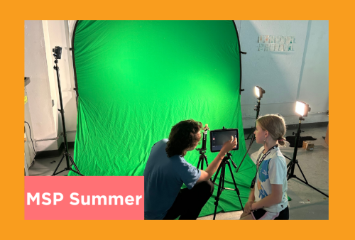 a teacher shows a young student how to light a green screen for color keying in post production
