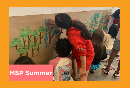 students work on a group project on butcher paper 