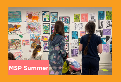 students admire a salon style hanging of their work 