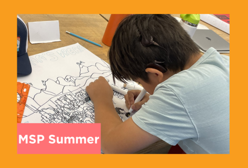 a young student is deep in concentration as he inks a comic of his dream