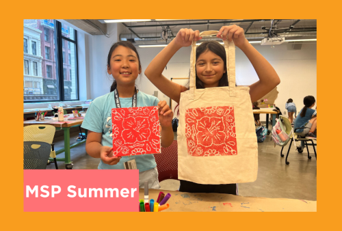 two young students hold up their printed tote bag