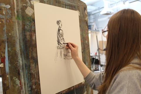 Student drawing figure