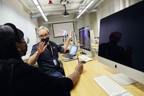 Instructor and Student in front of computer