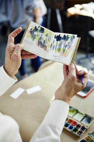 hands holding small book