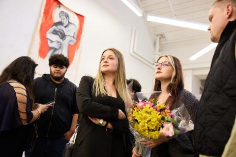 student holding flowers