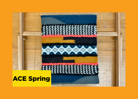 a hand woven pattern of fabric still attached to its loom
