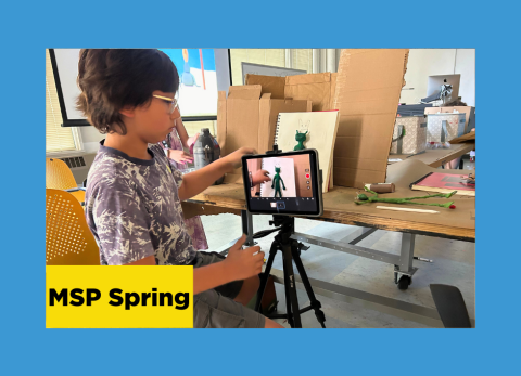 a young boy positions the camera from his ipad as he captures images for his stop-motion animation project at the school of the art institute of chicago