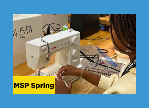 a young girl feeds fabric from her clothing design through a sewing machine