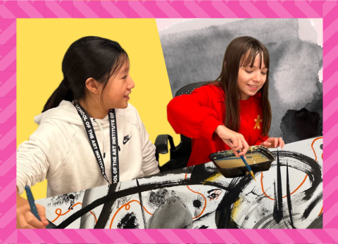 two girls sitting in their art studio experimenting with mark-making