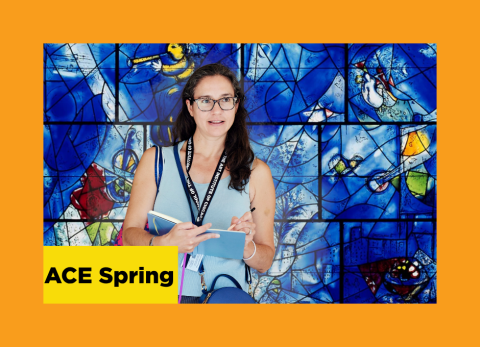 a woman looks lovingly at Chagall's stained glass piece America Windows