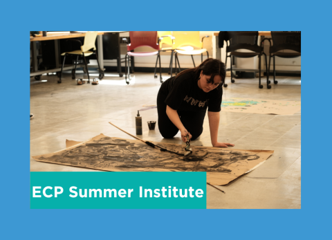 a student paints while on all fours looking over her butcher block paper