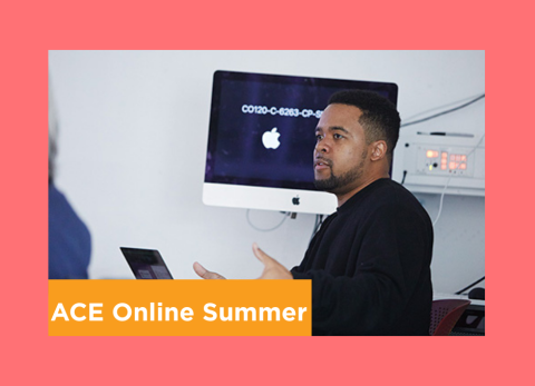 a student explains concepts of graphic design in front of an apple computer. 