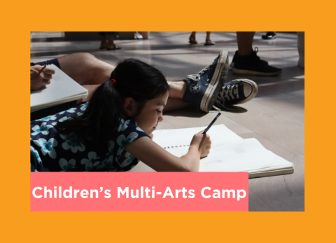 a young girl lays on the floor and draws dappled with sunlight