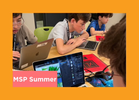 a group of young boys are deep in concentration together as they design video games and nerd out