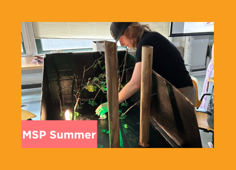 a student sets up a stage to film their animation project