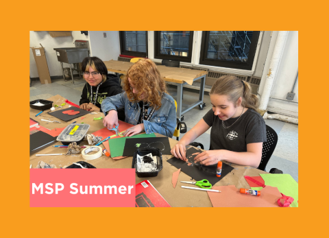 a group of young students happily experiment with multi-media tools as they bring their creations to life