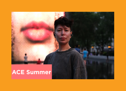 a young person stands in front of an outdoor sculpture fountain looking fierce
