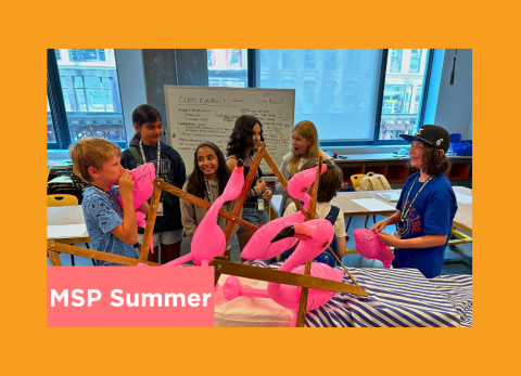 a group of kids play with inflatable flamingos