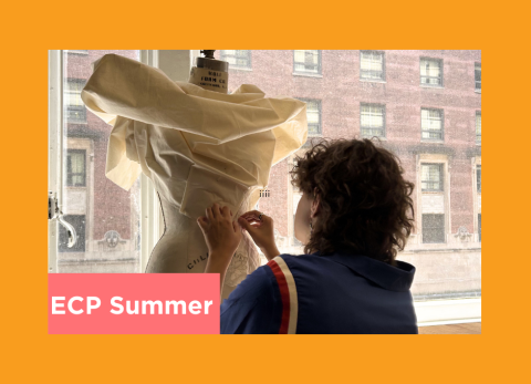 a girl pins a dress that looks like winged victory