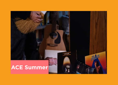 a person plays air guitar on a broom in front of his police and david bowie records