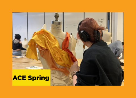 a student pins her orange and yellow fabric to a dress form 