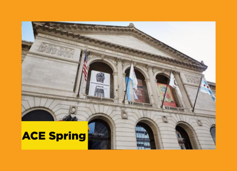 Looking up at the front facade of an art museum, with flags hanging down