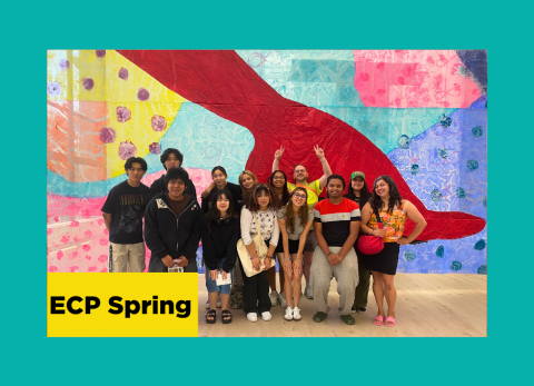 Students gathered together in front of a fiber art piece in excitement